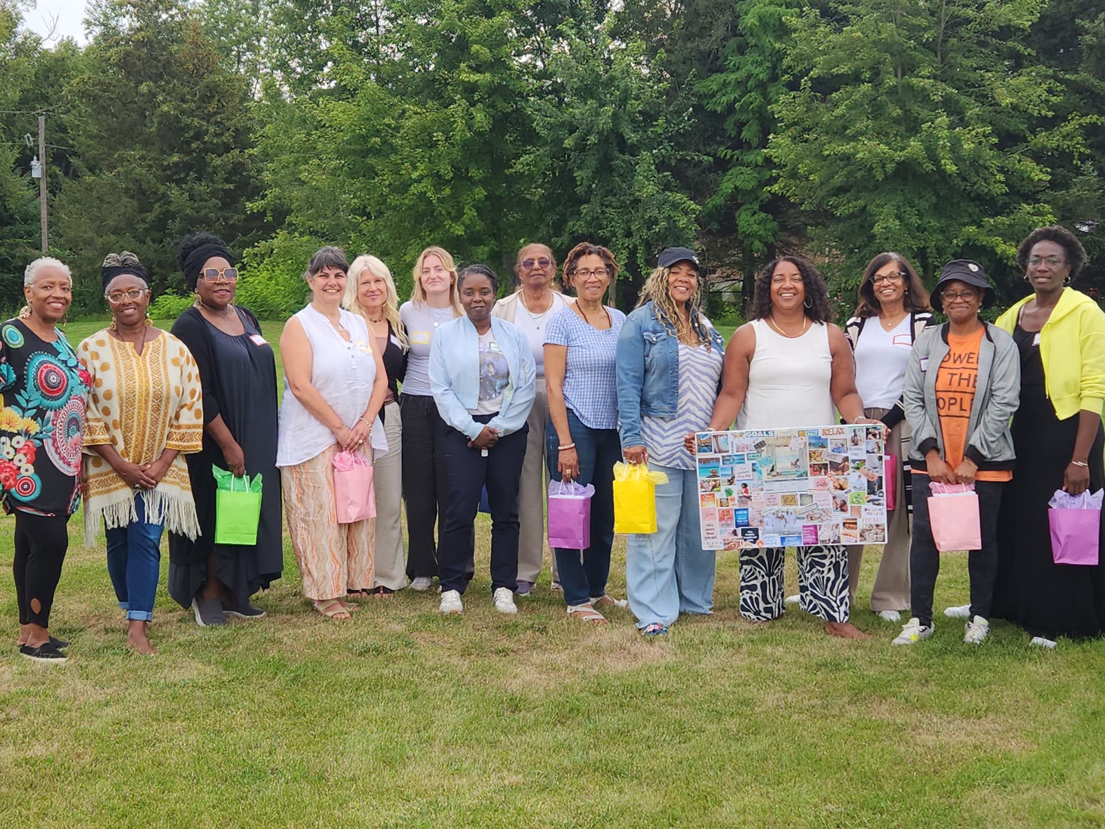 The Vision Board and Manifestation workshop group outdoors, Isis in gold second from the left, an attendee holding her vision board